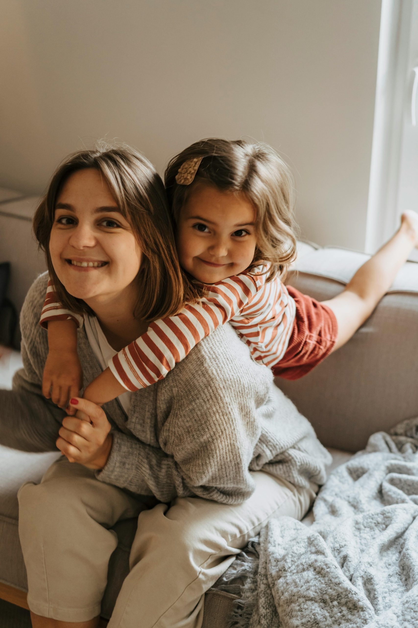 A happy mother and daughter enjoying quality time together at home in a cozy atmosphere.